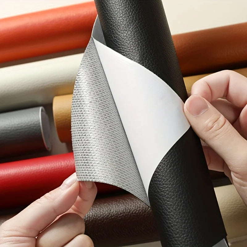 Hands peeling the backing off a black peel-and-stick leather repair sheet